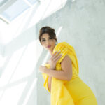 "Yellow pencil-cut evening dress from Mores Couture, crafted from premium lycra crepe with a chic cross-platted taffeta detail, one-side shawl, and open-back design, perfect for exclusive events in the UAE."