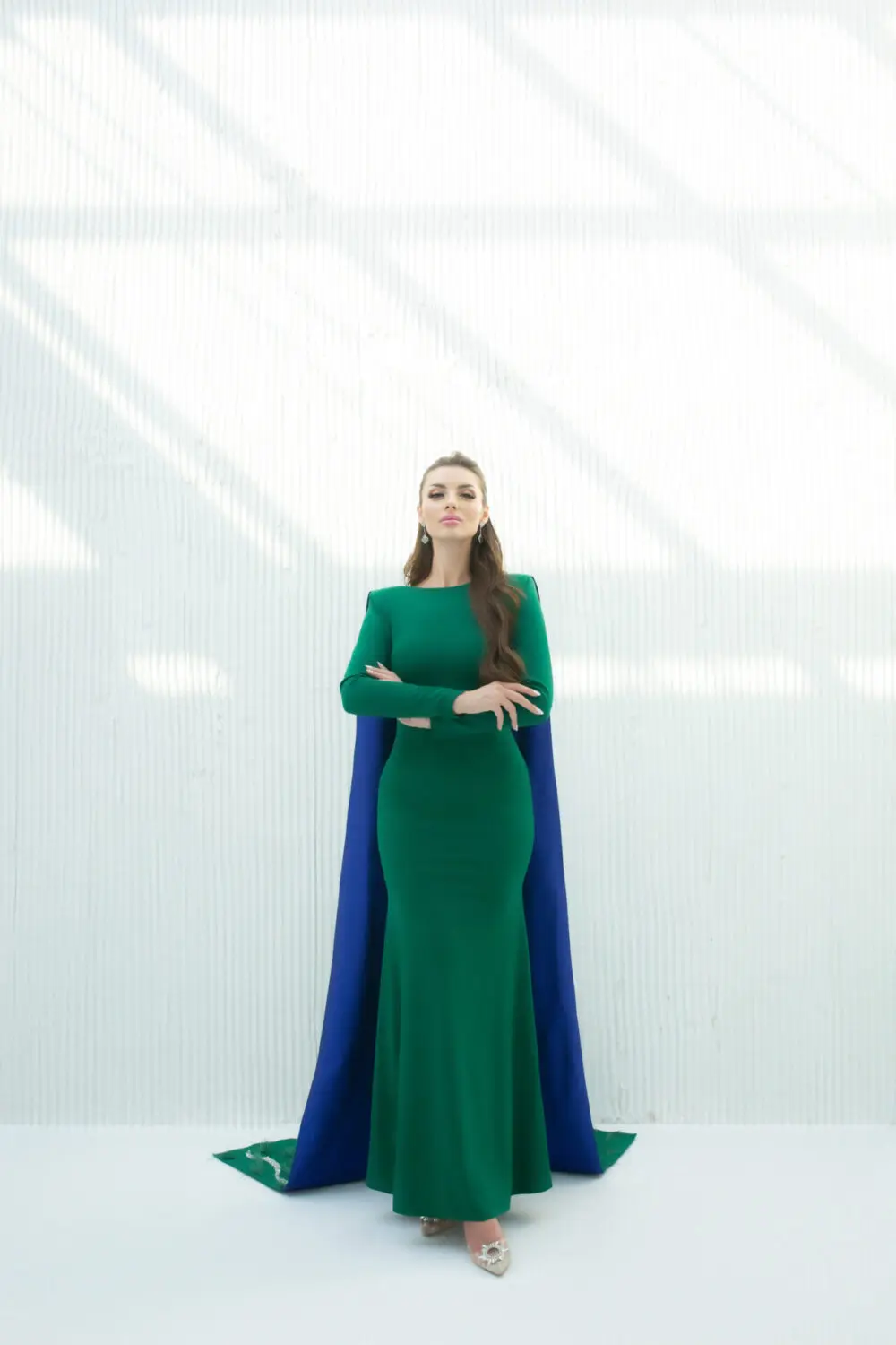 "Shaza green mermaid evening dress with blue taffeta shawl and embroidered feathers and pearls on the back. Elegant choice for formal events."