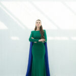 "Shaza green mermaid evening dress with blue taffeta shawl and embroidered feathers and pearls on the back. Elegant choice for formal events."